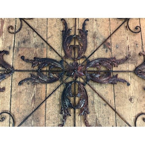 690 - A Metal Circular & Radiating Wall Mirror & a Decorative Floral Applique. Measuring: 103cms x 103cms.