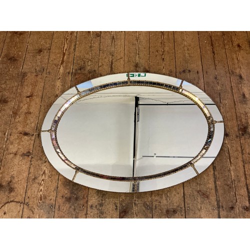 691 - A Metal Effect Oval Wall Mirror with inset Central Looking Glass. Measuring: 103cms.