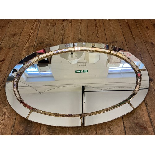 691 - A Metal Effect Oval Wall Mirror with inset Central Looking Glass. Measuring: 103cms.