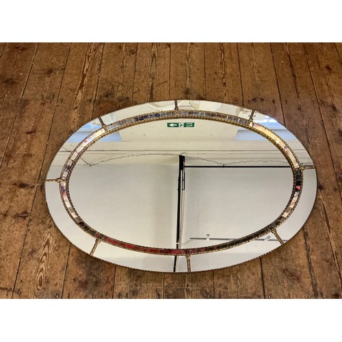 691 - A Metal Effect Oval Wall Mirror with inset Central Looking Glass. Measuring: 103cms.