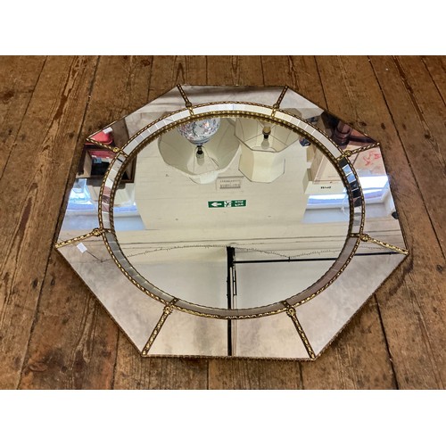 692 - A Metal Effect Octagonal Wall Mirror with inset Central Looking Glass. Measuring: 74cms.