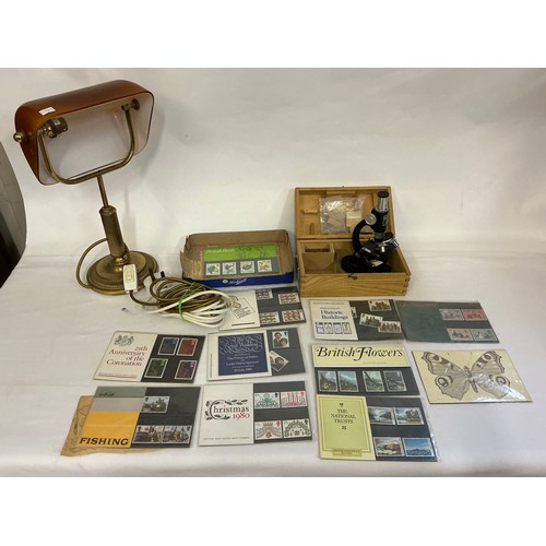694 - A Vintage Brass effect Students Lamp with a Smokey Glass shade, a Microscope & a quantity of First D... 