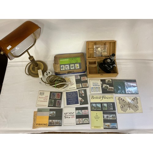 694 - A Vintage Brass effect Students Lamp with a Smokey Glass shade, a Microscope & a quantity of First D... 