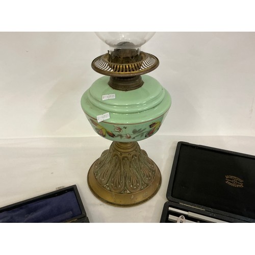705 - A Victorian Oil Lamp with Glass Reservoir along with Two Cased Sets of Drawing Instruments.