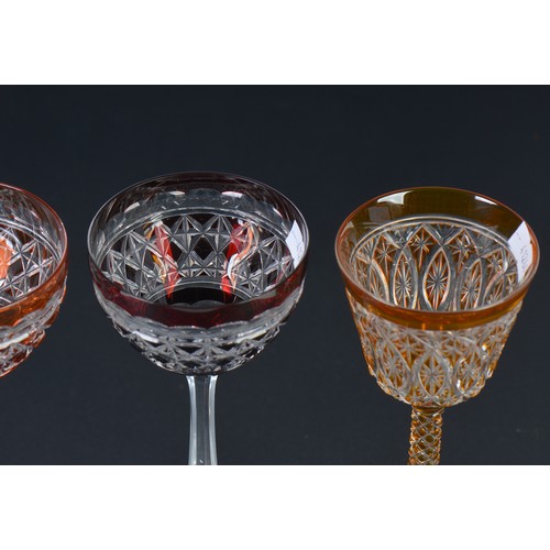 729 - An Amber cased Cut Glass & Pineapple stem Wine Glass on a Cut Star Base. Measuring: 22cms high. Alon... 