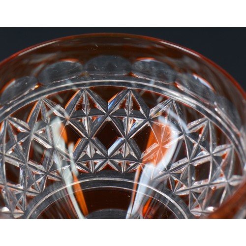 729 - An Amber cased Cut Glass & Pineapple stem Wine Glass on a Cut Star Base. Measuring: 22cms high. Alon... 