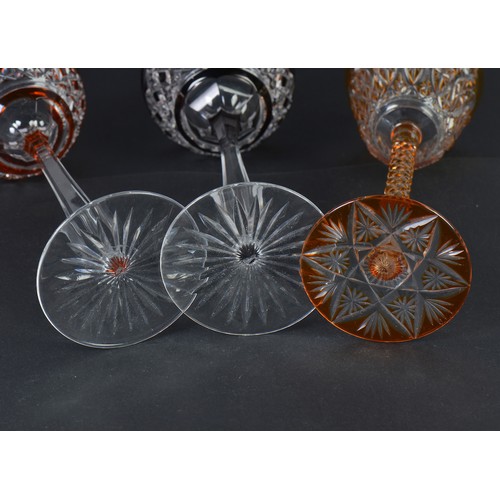 729 - An Amber cased Cut Glass & Pineapple stem Wine Glass on a Cut Star Base. Measuring: 22cms high. Alon... 