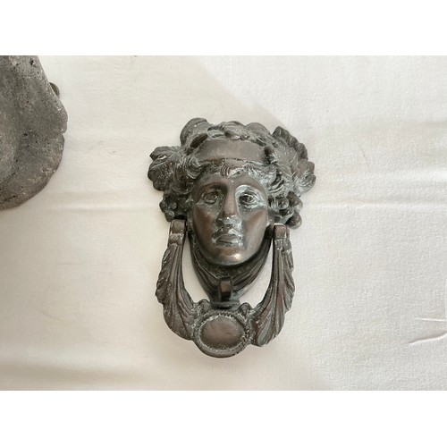 881 - A Bronze Door Knocker of a Young Ladies Head & a Pottery Temple God Head.