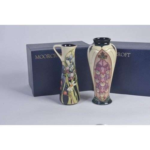 901 - A White ground Moorcroft Jug & a similar Vase Complete with Original Boxes & Paperwork. Measuring: 1... 