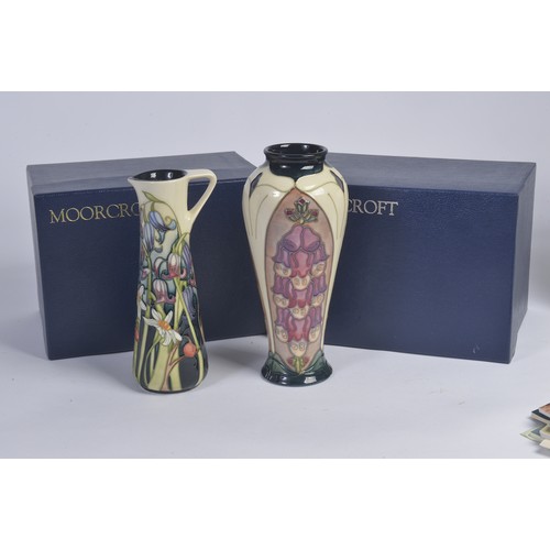 901 - A White ground Moorcroft Jug & a similar Vase Complete with Original Boxes & Paperwork. Measuring: 1... 