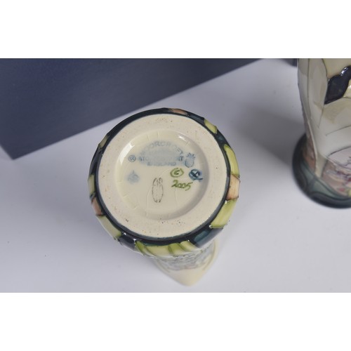 901 - A White ground Moorcroft Jug & a similar Vase Complete with Original Boxes & Paperwork. Measuring: 1... 