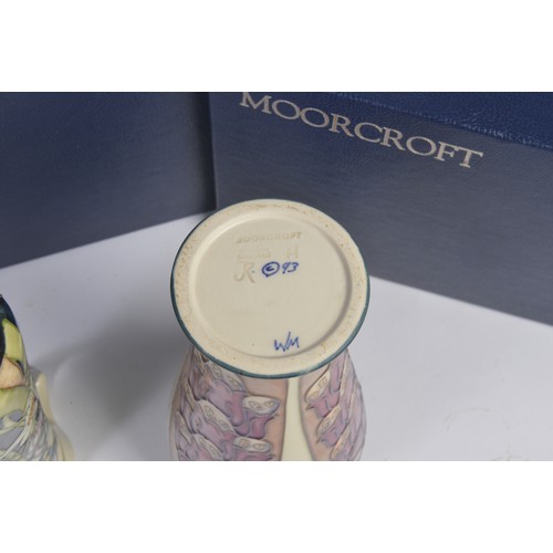 901 - A White ground Moorcroft Jug & a similar Vase Complete with Original Boxes & Paperwork. Measuring: 1... 