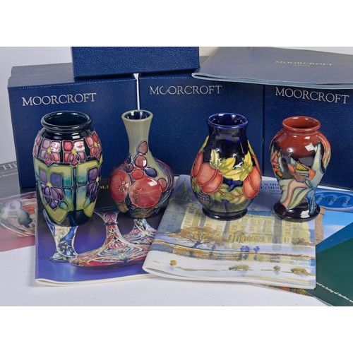 909 - Four various Moorcroft Vases Complete with Original Boxes & Paperwork. Measuring: 10cms High. (Appro... 