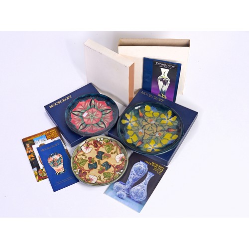 915 - A Blue & Green Glazed Moorcroft Pottery Saucer Dish decorated with Flowers & Two Moorcroft Year Plat... 