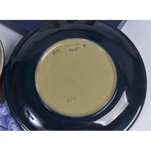 915 - A Blue & Green Glazed Moorcroft Pottery Saucer Dish decorated with Flowers & Two Moorcroft Year Plat... 