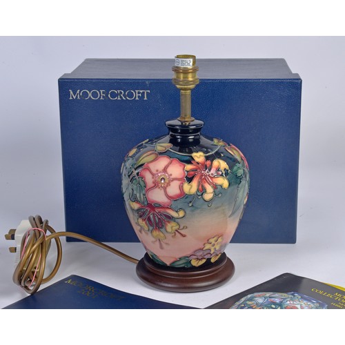 916 - A Fuchsia decorated Moorcroft Lamp Complete with the Original Box & Paperwork. Measuring: 18cms High... 