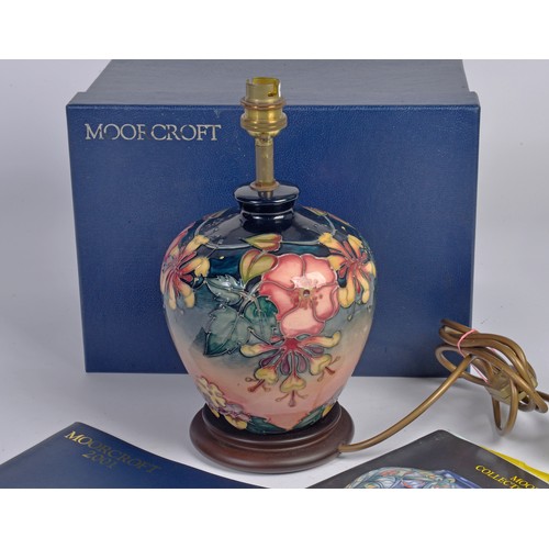 916 - A Fuchsia decorated Moorcroft Lamp Complete with the Original Box & Paperwork. Measuring: 18cms High... 