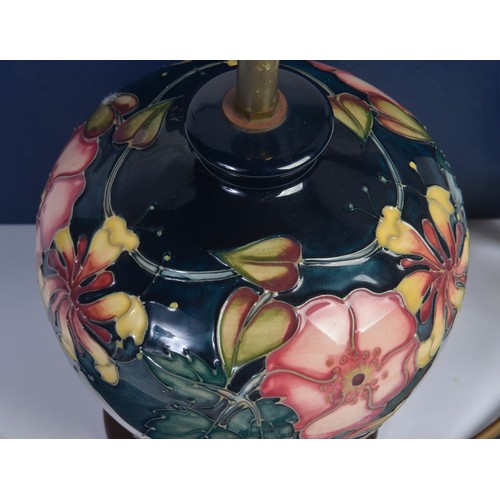 916 - A Fuchsia decorated Moorcroft Lamp Complete with the Original Box & Paperwork. Measuring: 18cms High... 