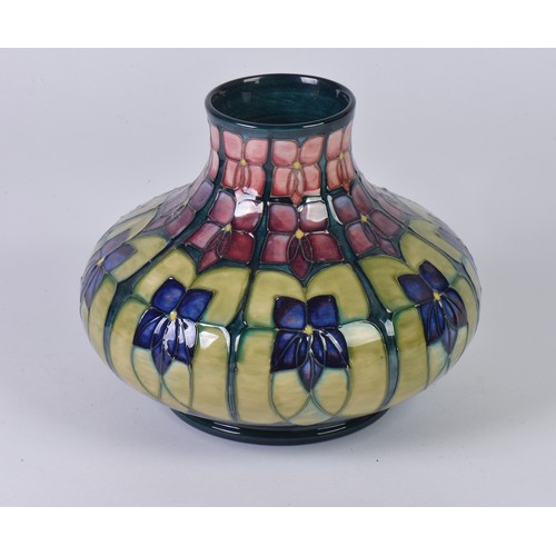 917 - An Art Nouveau design Squat patterned Moorcroft Vase decorated in Purple & Green Complete with Origi... 