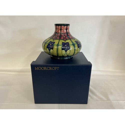 917 - An Art Nouveau design Squat patterned Moorcroft Vase decorated in Purple & Green Complete with Origi... 