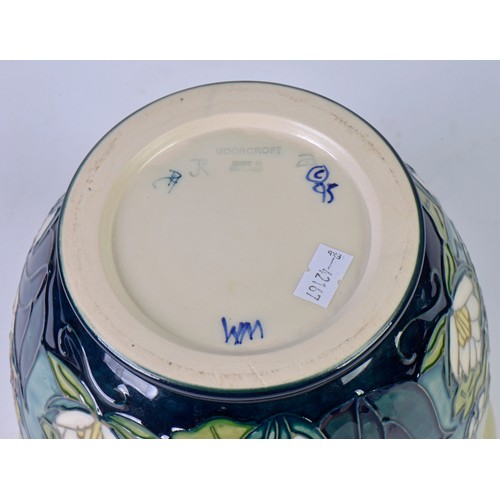 918 - A Moorcroft Jardiniere decorated with Lilly's & Iris's. Measuring: 17cms high.