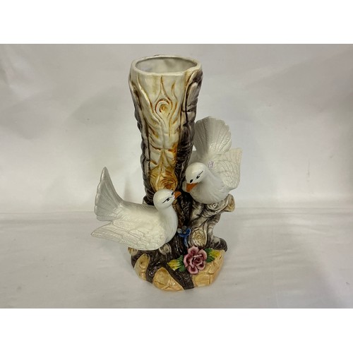 919 - An Italian Porcelain Vase decorated with Doves. Marked N. Measuring: 42cms.