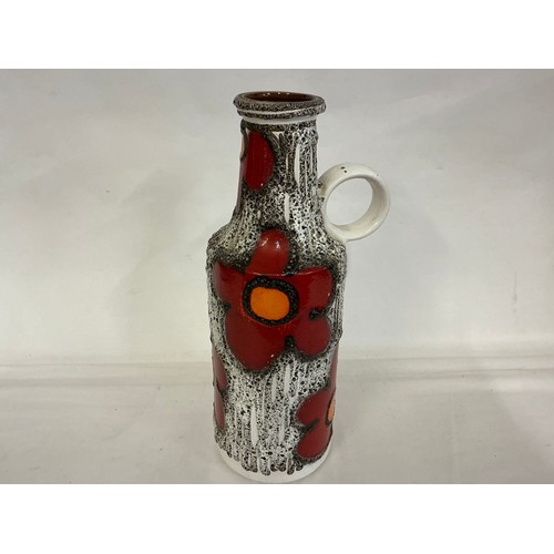921 - A Fat Lava German made Runny Glazed Ewer Vase decorated with Red Flowers. Measuring: 39cms High.