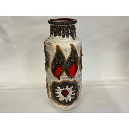 922 - A Fat Lava German made Runny Glazed Vase decorated with Flowers & Flaming Ears. Measuring: 54cms.