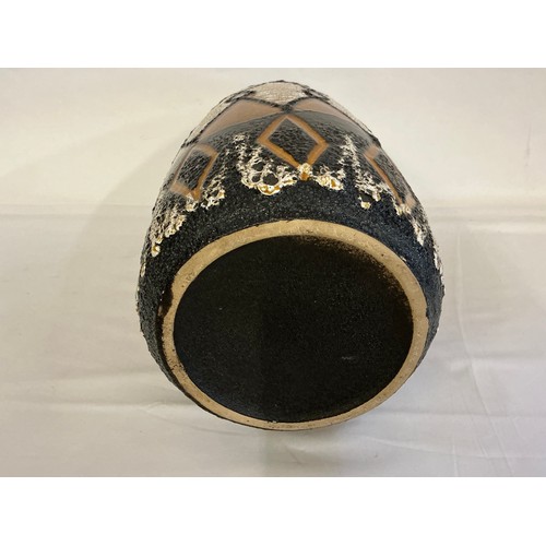 923 - A Fat Lava German Lava Glazed African Stool pattern Vase. Measuring: 48cms High.