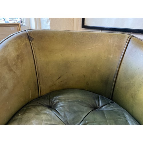 651 - A Mahogany Framed Green Leather & Studied Hoop Back chair resting on turned Legs.