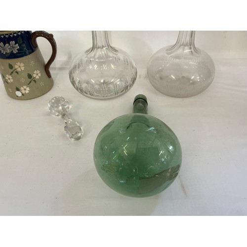 725 - A Green Bottle Shaped Vase taken from Dunkirk, two decanters & a Lovett Jug.