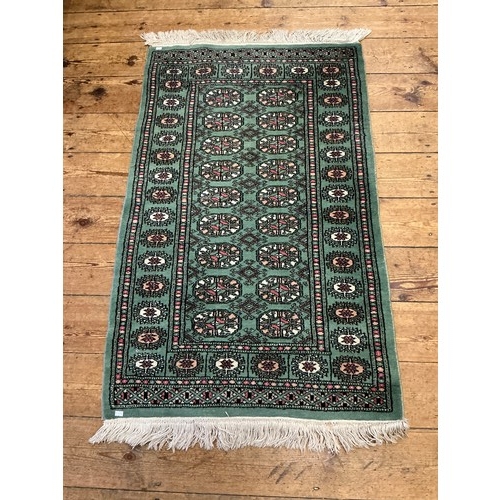 677 - A Green Ground Central 18 Gull, Double Egg Border Persian Carpet/Rug. Measuring: 130cms x 80cms.
