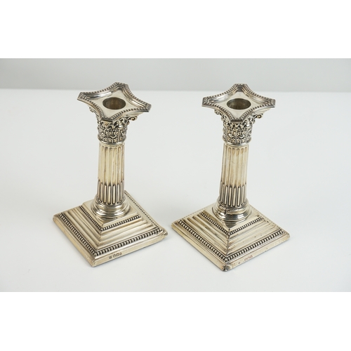 24 - A pair of late Victorian silver candlesticks by Fordham & Faulkner, with weighted bases. One hallmar... 