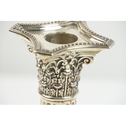 24 - A pair of late Victorian silver candlesticks by Fordham & Faulkner, with weighted bases. One hallmar... 