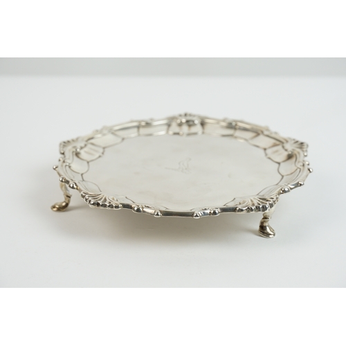 54 - A Georgian silver salver by Thomas Hannam & Richard Mills. The salver rests on three hoof feet. The ... 