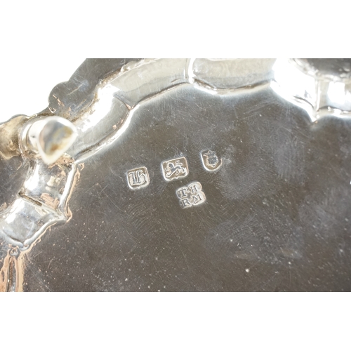 54 - A Georgian silver salver by Thomas Hannam & Richard Mills. The salver rests on three hoof feet. The ... 