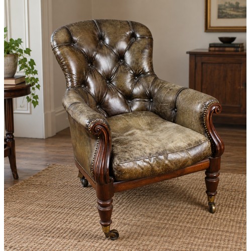 A leather Victorian library chair, in green leather, and casters.