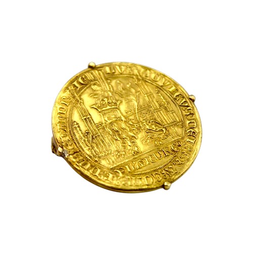 A 12th Century design Gold coin decorated with a lion and made into a brooch.