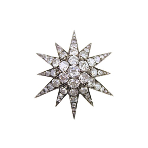 A Victorian 9 carat diamond mounted starburst brooch, mounted with a cluster of 7 central diamonds and others surrounding, approximately 68 diamonds in total, mounted with a screw back and pendant mount. Size approximately 4cm. Weight approximately 6.8g.