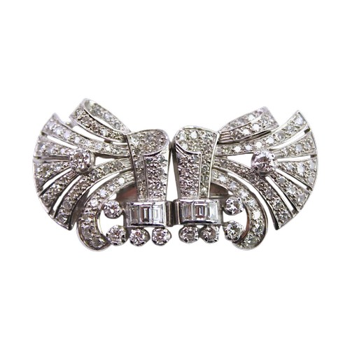 A Ladies Platinum diamond set brooch, mounted with two fold over prong clips, set with 130 Diamonds varying in size from approx 0.04ct to 0.20ct, including 6 set baguette diamonds. Total weight 23.8g. Estimate diamond weight 5.0ct.