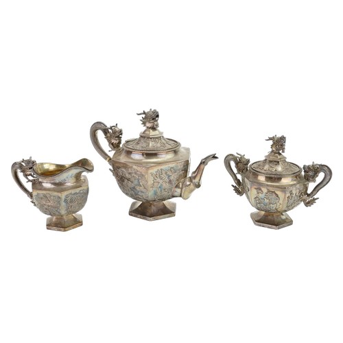 A "Wang Hing" Chinese Export Silver 3 Piece Tea Set marked 90 with Dragon decorated Finials, Prunus Leaves & Dragons in Clouds. Weighing: 1659 grams.