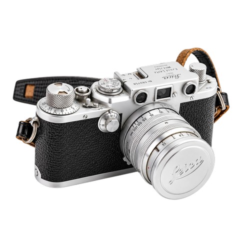 A Scarce "Leica 11F Camera" (Nr: 593758) in Original Leather Case, a Leica Lens in Plastic Container, a Leica Light Meter in Original Case, a Large Leica Lens in Leather Case along with various Original Leica Instruction Booklets & the Original Purchase Receipt from 1952.