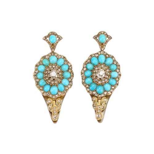 A stunning pair of old cut diamond earrings converted to clasps, set with oval turquoise stones. Circa 1820. Largest Diamond approx 4.4mm x 3.8mm. Set with old oval cut diamonds. The clasps are mounted with 13 turquoise stones and chip Diamonds. Size 42.2mm x 19mm.