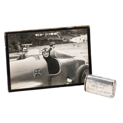An interesting Silver match stick case, presented from the skipper on Feb 4th 1927 to congratulate Beard & Fitch LTD for the dynamic gear and manufacturing supplies for Malcom Campbells blue bird 1927, that achieved the land speed record travelling at 174.88mph. The blue bird that achieved the land speed record was fitted with the transmission products manufactured by B. & F. Along with a Photo of Malcolm Campbell in Blue Bird with "Father Fitch" in background with the hat.
