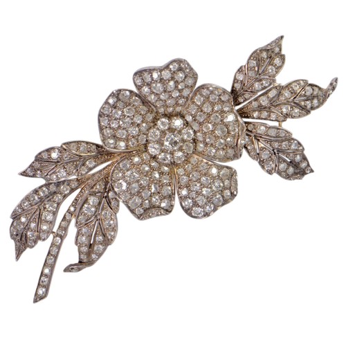 A Victorian diamond set floral spray brooch, pavé set throughout with old cut diamonds. The principal diamond is approximately 0.33ct. Tests as 9ct gold and silver mounted. Length 9.7cm, total weight 23.6g.