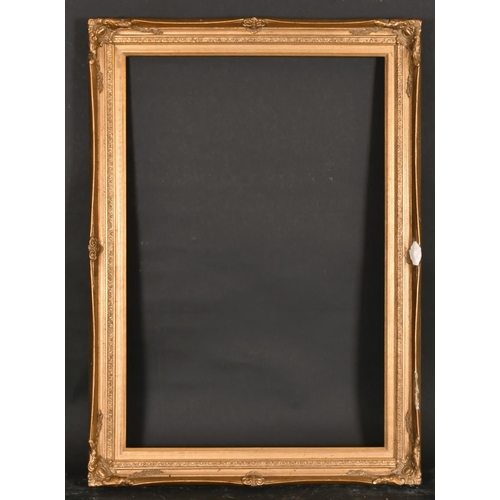 452 - 20th Century English School. A Gilt Composition Frame, with swept centres and corners, rebate 30” x ... 