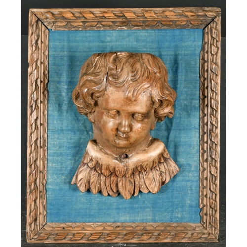 36 - 19th Century European School. A Winged Putto, Carved walnut on a blue silk backing within a carved f... 