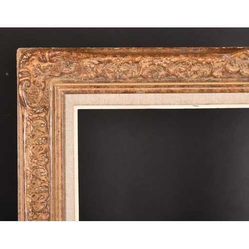 239 - Early 20th Century French School. A Gilt Composition Frame, with swept centres and corners and a fab... 