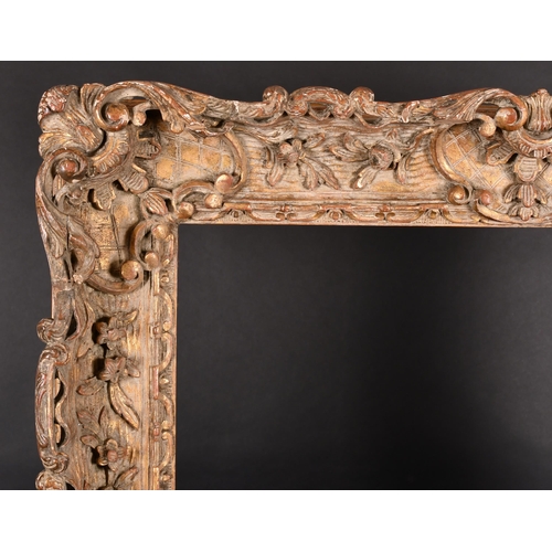 242 - 19th Century French School. A Carved Giltwood Frame, with swept centres and corners, rebate 30