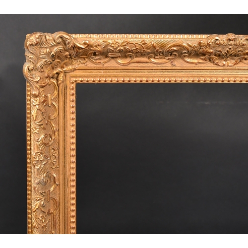 404 - 20th Century European School. A Gilt Composition Frame, with swept centres and corners, rebate 27